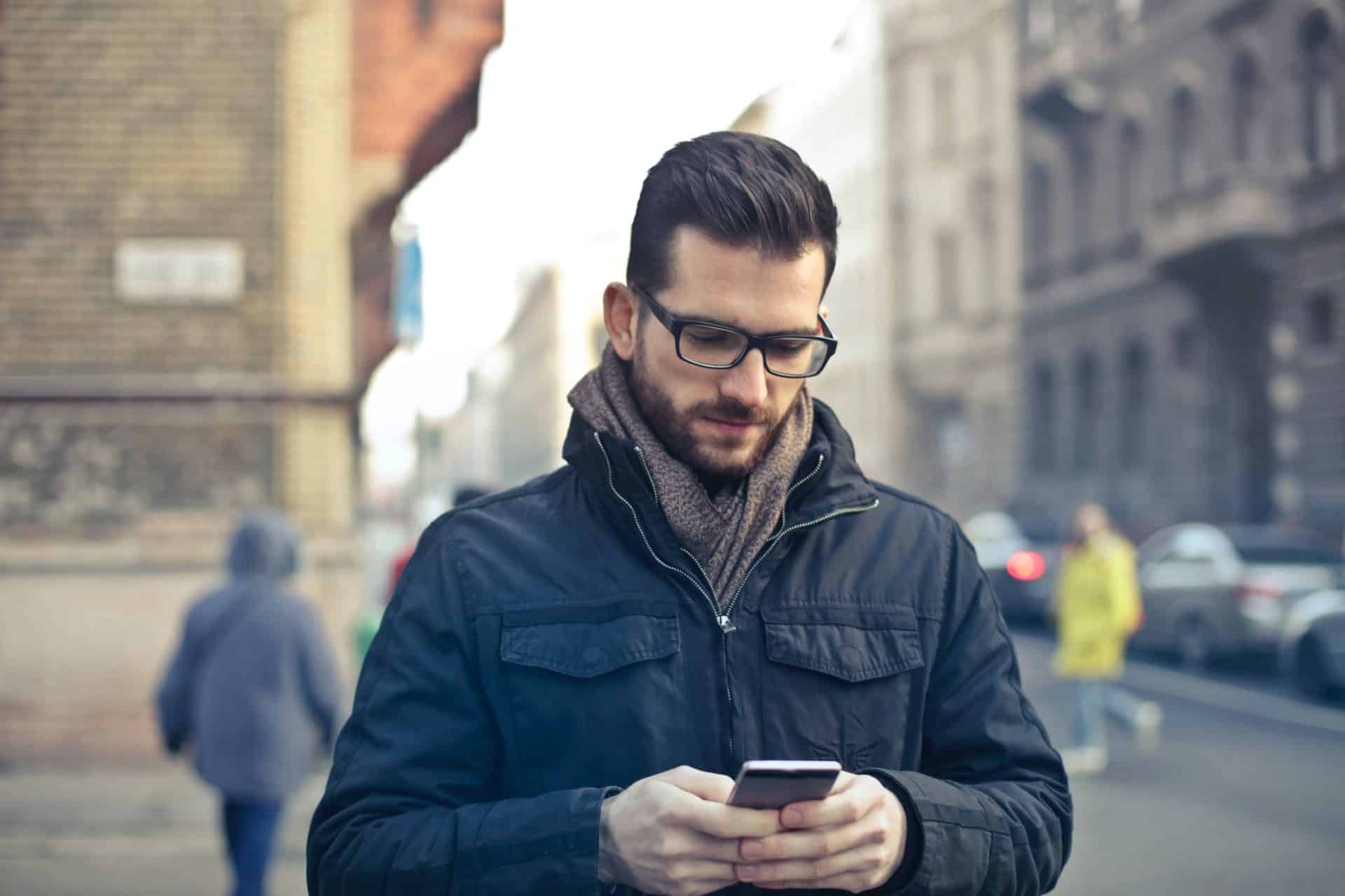 Photo by Andrea Piacquadio: https://www.pexels.com/photo/man-wearing-black-zip-jacket-holding-smartphone-surrounded-by-grey-concrete-buildings-775091/